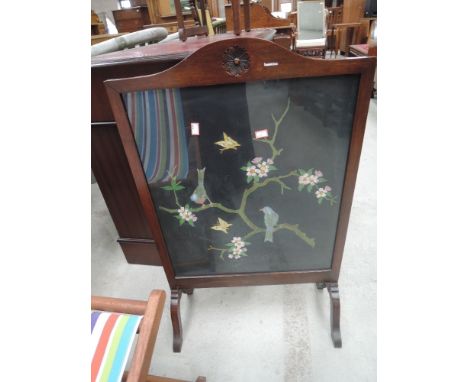 A 1920's mahogany frame firescreen having embroidered bird and branch inset
