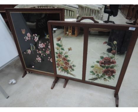 A 1920's oak frame firescreen having embroidered bird and foliage inset and a painted mirror inset firescreen