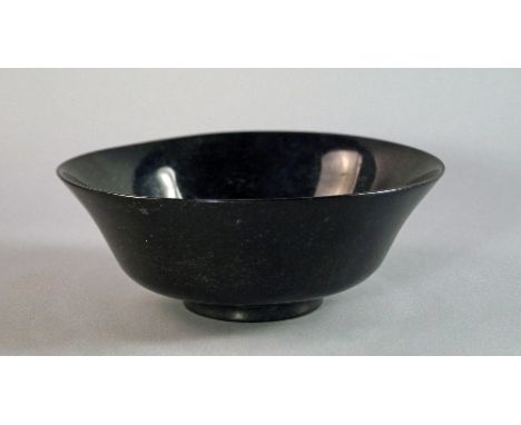 A Mughal style spinach jade bowl, of flared form, raised on circular foot, 16cm wide.   CONDITION REPORT: general light wear.