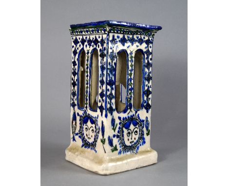 A Persian style blue and white pottery light shade / stand, 20th century, decorated with faces, fish and foliage, 23cm high