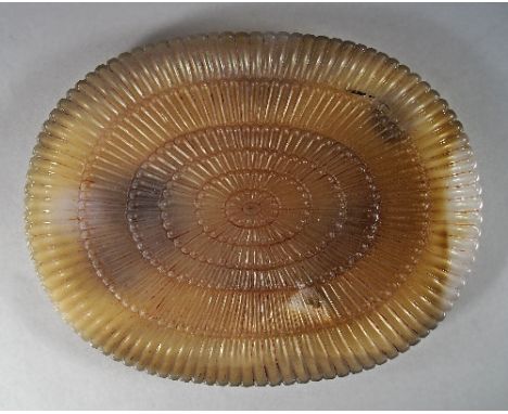 A mutton fat jade style oval dish in the Mughal taste, the edge with semi circular ridged rim, with lobed exterior and stylis