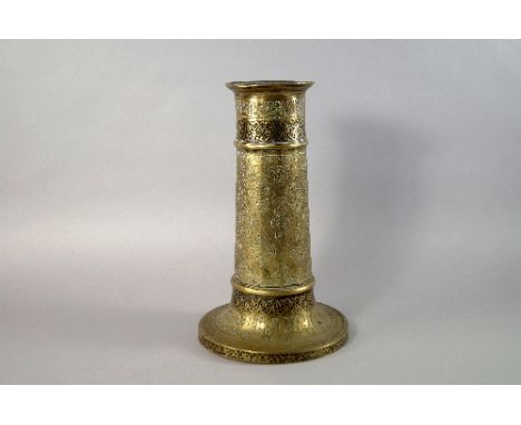 A Safavid brass candlestick, 17th century, of faceted cylindrical form, with engraved panels of scrolling foliage and script,