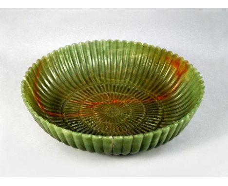 A jade style circular dish in the Mughal taste, the edge with semi-circular ridged rim, with lobed exterior, carved to the in