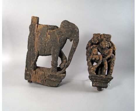 An Indian wooden carving of an Elephant, 19th century or earlier, part of an architectural element, modelled standing on a pl