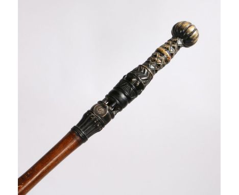 Early 20th Century Ashanti walking stick, the ebonised gadrooned terminal above a diamond and pierced engraved lower section 