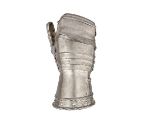 A FINE GERMAN MITTEN GAUNTLET FOR THE RIGHT HAND, CIRCA 1520, PROBABLY AUGSBURG, formed of a flared tubular cuff decorated ov