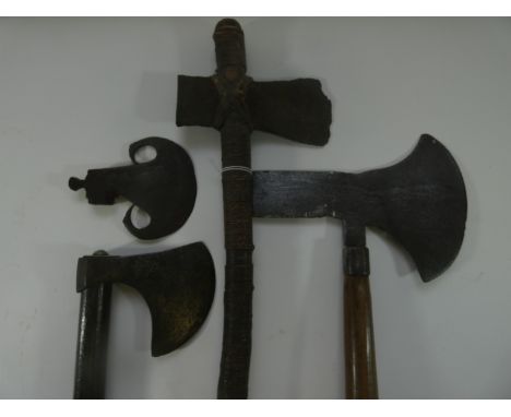 AN INDIAN AXE, 19TH CENTURY AND THREE FURTHER AXES, the first of bearded form, with curved blade, open socket decorated with 