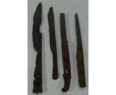 A COLLECTION OF EARLY KNIVES, 14TH/15TH CENTURIES, in excavated condition, the first with tapering single-edged blade enclose