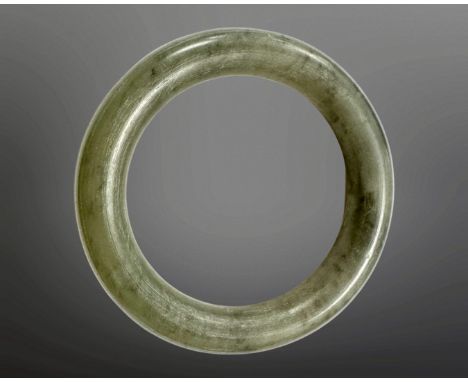 A carved jade circular bangle, inner diameter 58mm.
