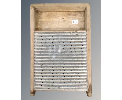 A vintage metal and pine wash board 