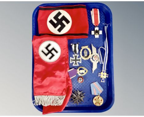 A tray of reproduction German WW II medals, badges, sash and armband 