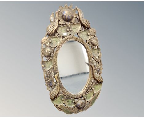 A decorative framed oval mirror 