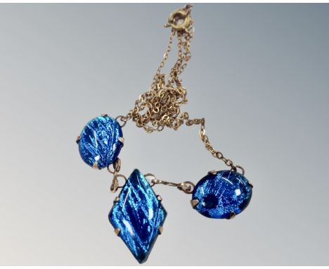 A vintage Art Deco blue butterfly wing necklace in rolled gold