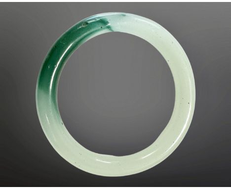 A carved jade circular bangle, inner diameter 58mm.
