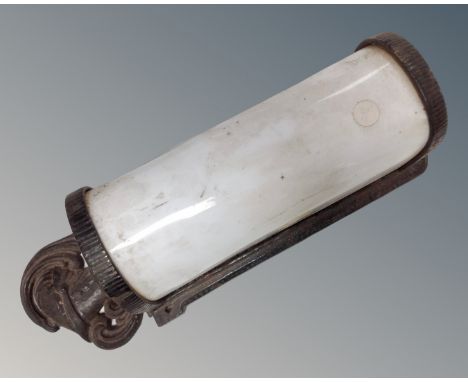 An antique metal and white glass wall light mounted with knight head 