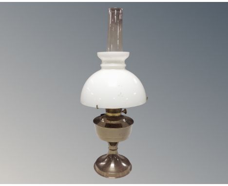 An Aladdin chrome oil lamp with chimney and shade 