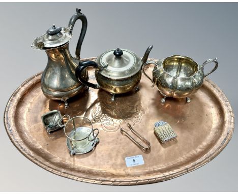 An oval copper tray, diameter 55cm, together with a group of plated wares including teapot, tongs, a Colibri lighter etc. 