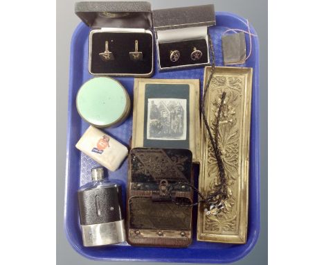 A tray containing cuff links, a brass embossed pen tray, hip flask, dressing table pot, miniature letter rack.