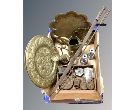 A box of assorted metal ware, Eastern trays, brass jugs, scales, weights, 19th century sword and fire poker 