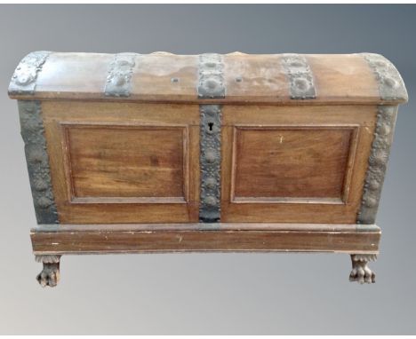 A 19th century Continental oak iron bound domed shipping trunk on stand with lion paw feet 