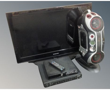 A Samsung 32" LCD TV together with a Philips CD sound machine and security camera control box 