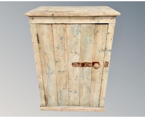 A vintage pine single door cabinet 