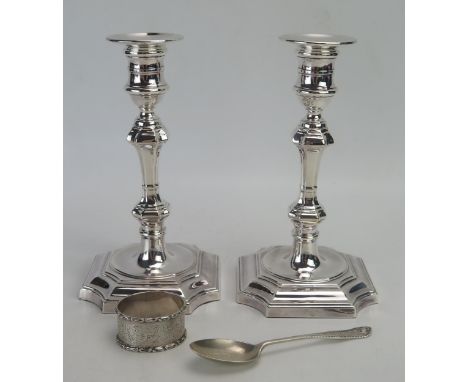 A pair of George II style plated candlesticks, on weighted shaped bases, 20cm high, together with a silver napkin ring and si