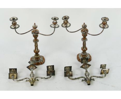 A pair of plated twin branch candelabra, with reeded swept branches on knopped stems, on weighted and shaped bases, together 