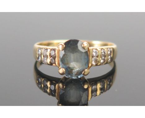 An 18ct Gold, Topaz and Diamond Ring, size I.5, indistinctly stamped 18, 2.49g