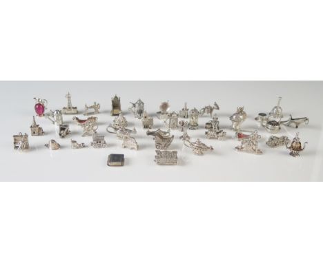 A collection of white metal charms, including cars, church, lamp, flagons, churches, throne etc. total weight 157gms, 5.06ozs