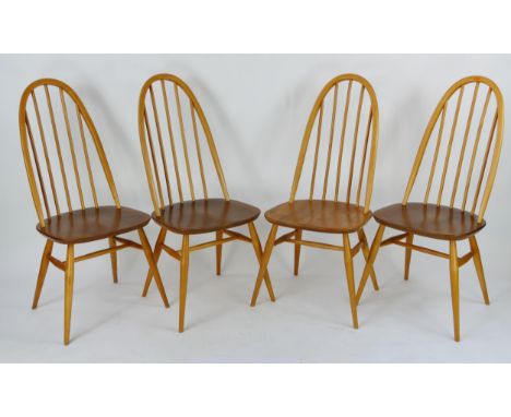 A set of four Ercol Quaker dining chairs with arched spindle backs above solid seat on turned legs. (4). 