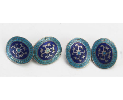 A pair of silver and enamel cufflinks. 