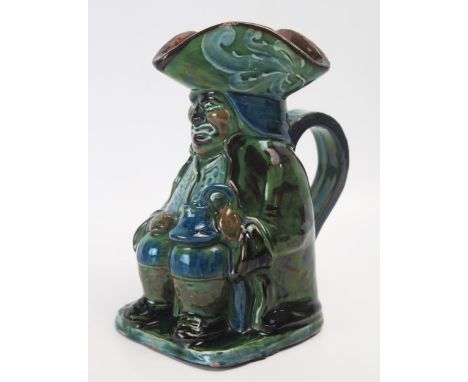 A Brannam pottery Toby jug, with variegated green and blue glaze, incised signature to the base, dated 1901, 15cm high. 