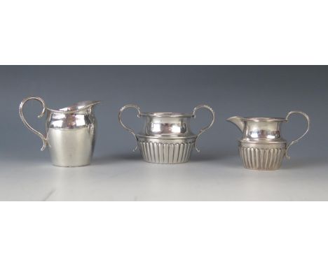 A matched silver twin handled sugar basin and cream jug,, together with another cream jug, various makers and dates, total we