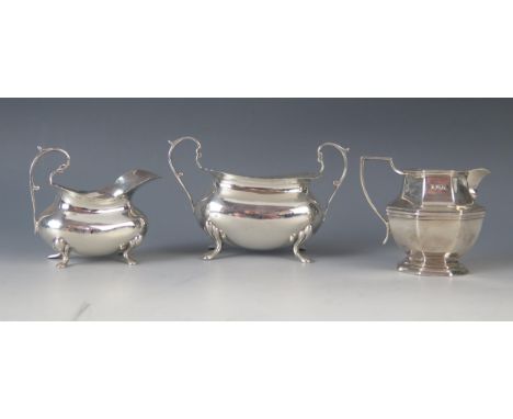 A silver twin handled sugar basin and matching cream jug, all marks are worn and rubbed, raised on swept legs, together with 