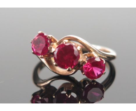 A 9ct Gold and Ruby Three Stone Ring, largest stone c. 5.6mm, size M.5, stamped 9CT, 3.75g 