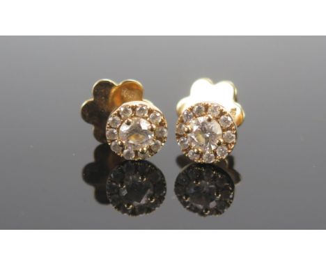A Pair of 18ct Gold and Diamond Cluster Stud Earrings, c. 4.43mm brilliant round cut principal stones, 7.9mm head, stamped wi
