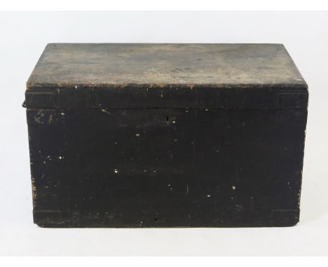 A large 19th century black painted wood trunk, the rectangular hinged lid enclosing two lift-out trays, with carrying handles