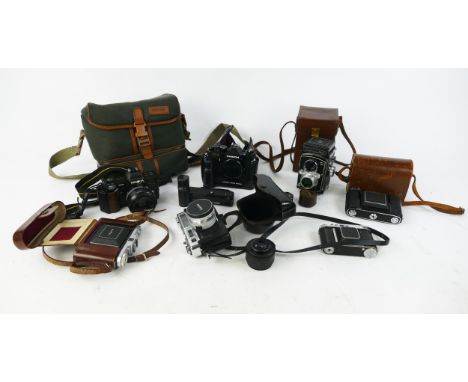 Collection of Vintage Cameras including Yashica Electro 35, Zeiss Ikonta, Kodak Retina II, Zeiss Nettar, Chinon CE-3, Minolta