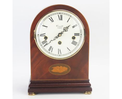 A mahogany and boxwood strung and inlaid mantel clock, of arched outline, with 14.5cm silvered Roman dial, the movement strik