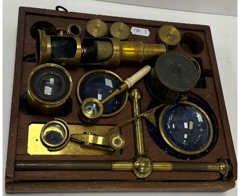 A 19th Century brass cased monocular microscope, together with various optics and accessories