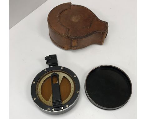 A vintage Prismatic compass with heavy leather bespoke case