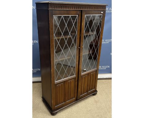 A 20th Century mahogany corner cupboard in the Georgian style with astragal glazed upper door over a panelled door on bracket