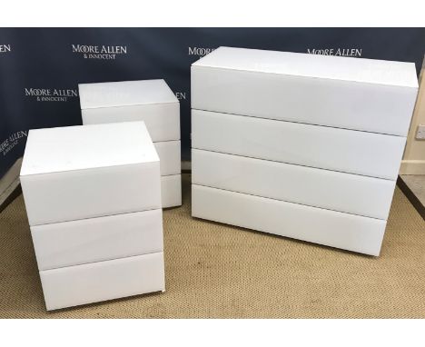 A white glass covered chest of four long drawers, 91 cm wide x 41 cm deep x 80 cm high, a pair of three drawer bedside chests