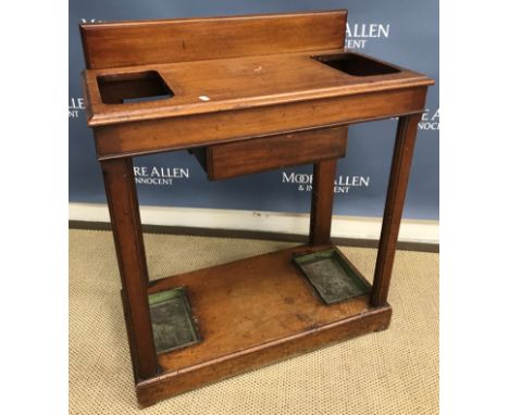 A late Victorian mahogany stick stand, the slightly raised back over two recesses and glove drawer on moulded supports united