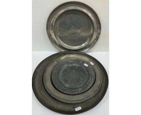 Five 19th Century pewter plates / chargers, one inscribed "E.G 1812" with wriggle work floral medallion to the centre, bearin