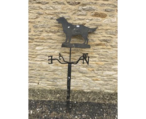 A black painted wrought iron weather vane of typical form with Retriever figure decoration, 72 cm W-E, 148 cm high including 