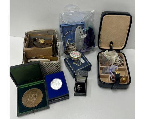A collection of assorted costume jewellery to include white metal bracelet, silver locket with engraved scrolling decoration,