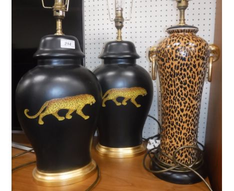 A pair of modern Rochamp black ground panther decorated table lamps 48 cm high including fittings and a panther print design 