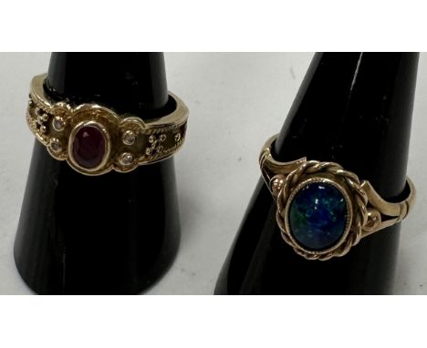 A 9 carat gold ruby and diamond set dress ring, size O/P, weight 4.4 g together with a yellow metal dress ring with blue and 